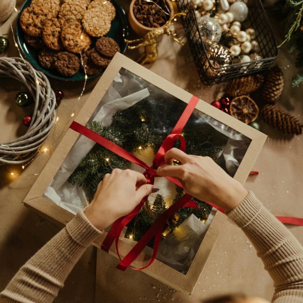 Top View of Woman Packing a Christmas Present